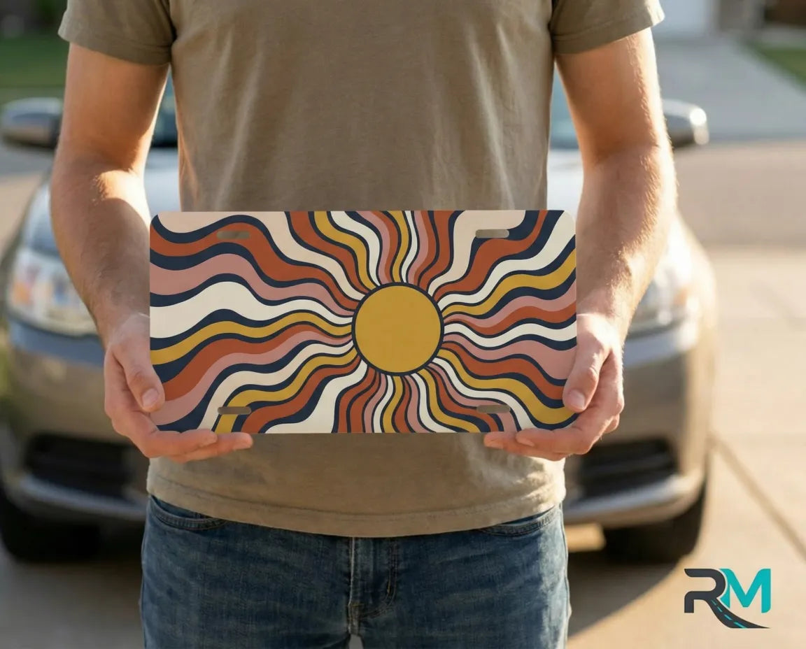 person holding retro wavy sun license plate — boho sunburst vanity plate orange art