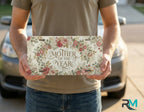 person holding mother of the year license plate — vintage floral vanity plate art