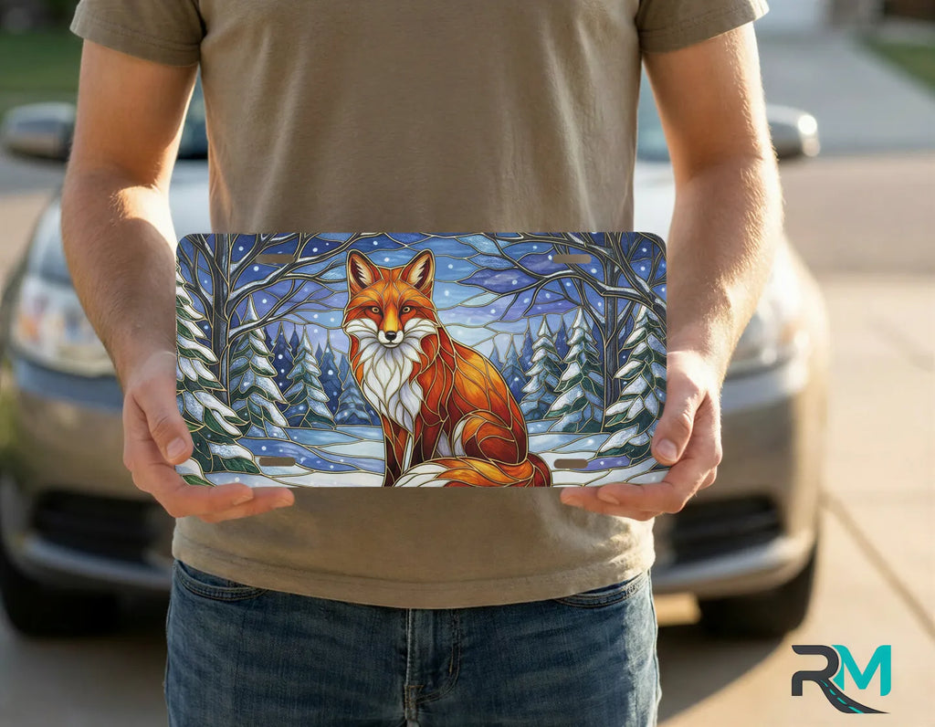 person holding red fox snowy forest license plate — warm amber winter fox vanity plate art