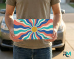 person holding retro colorful wave license plate — bright wavy sunburst vanity plate art