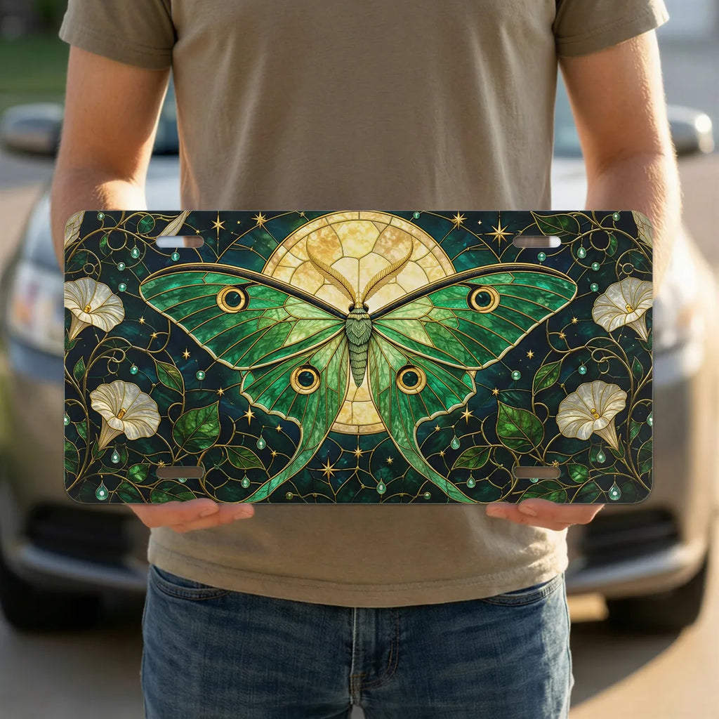 person holding luna moth vanity plate — emerald luna moth stained glass front license plate