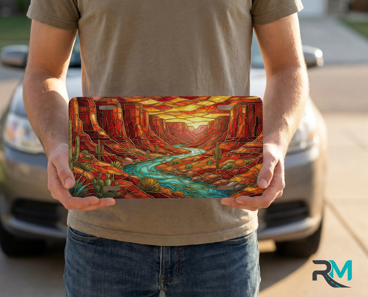 person showing desert canyon river vanity plate — turquoise creek red rock canyon molten sunset front license plate