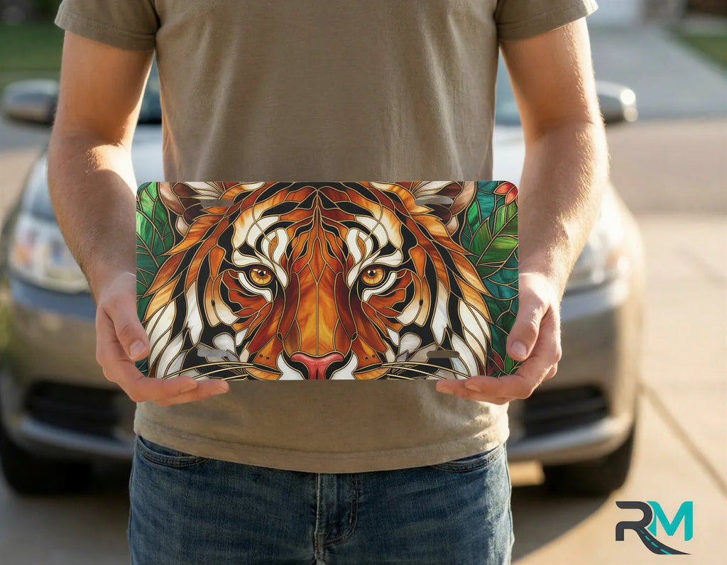 person holding stained glass lion license plate — amber gold lion vanity plate art