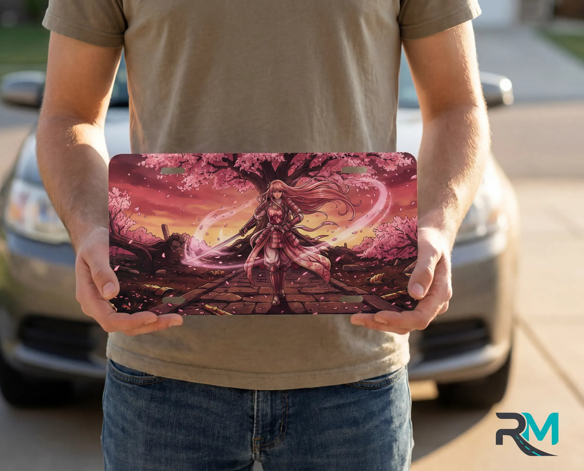 person showing samurai girl cherry blossom vanity plate — warm sunset pink sakura front license plate