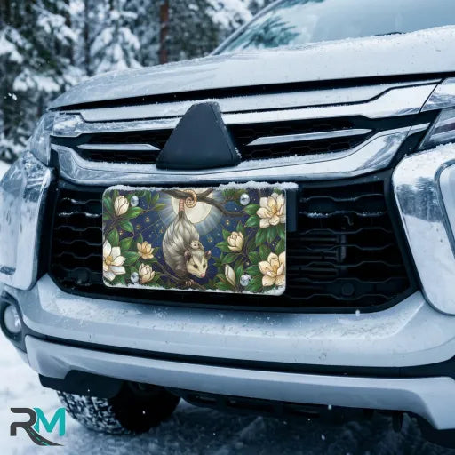 opossum moon vanity plate on car in snowy setting — moonlit opossum magnolia bloom design