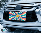 colorful wave license plate on car in snowy setting — bright wavy retro sunburst design