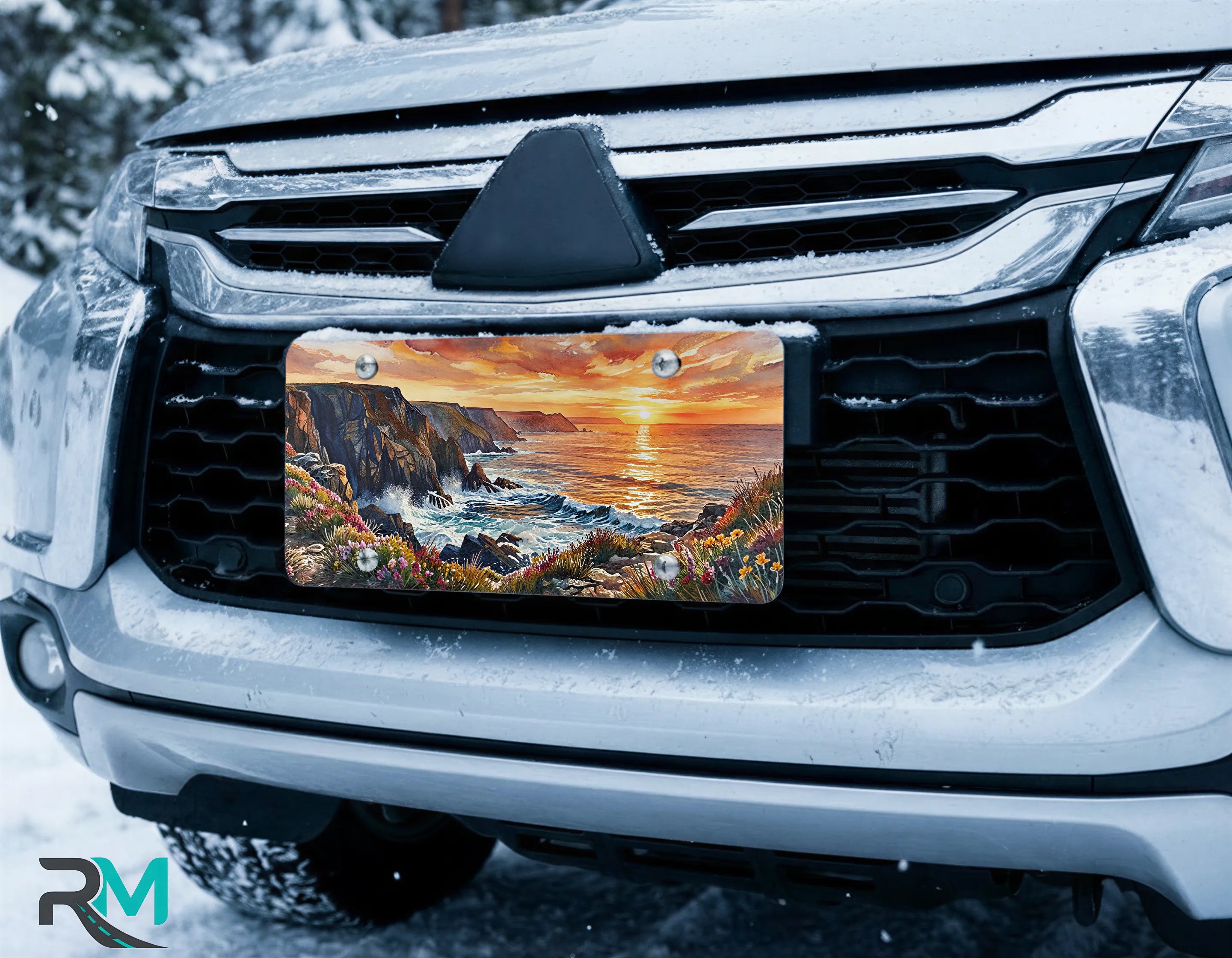 scenic front license plate on car in snowy setting — coastal cliffs sunset design