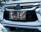 stormcaller vanity plate on car in snowy setting — electric blue gold lightning cliff stormy sea design
