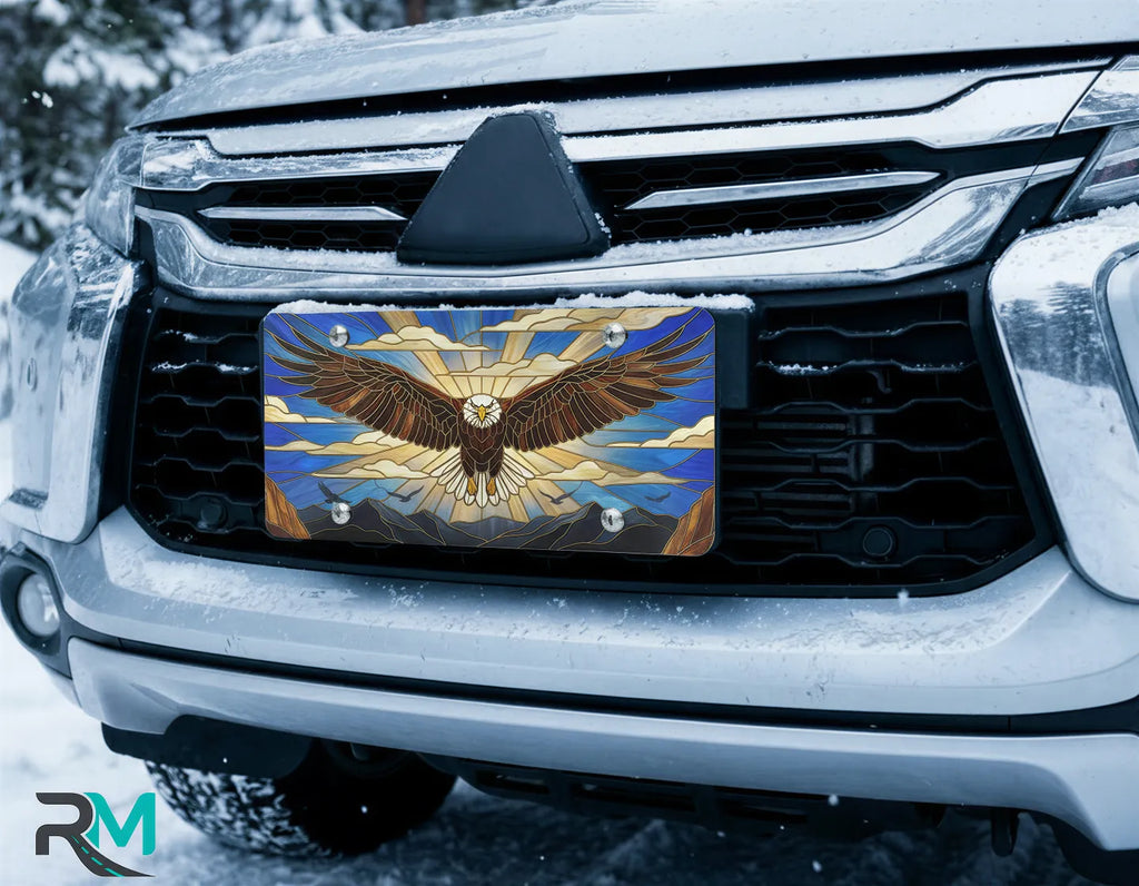 eagle license plate on car in snowy setting — stained glass soaring cobalt gold eagle design