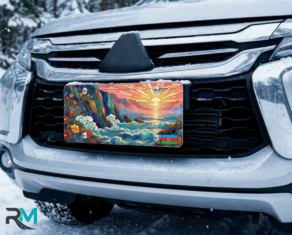 sunset ocean waves vanity plate on car in snowy setting — warm gold jewel teal sunrise ocean waves design