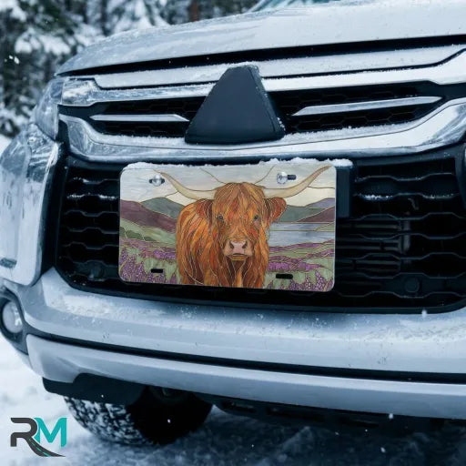 highland cow vanity plate on car in snowy setting — warm ochre lavender pastoral design