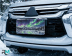 aurora borealis license plate on car in snowy setting — northern lights mountain scene design