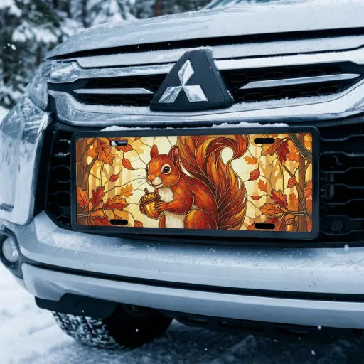 autumn squirrel vanity plate on car in snowy setting — warm amber squirrel acorn autumn design