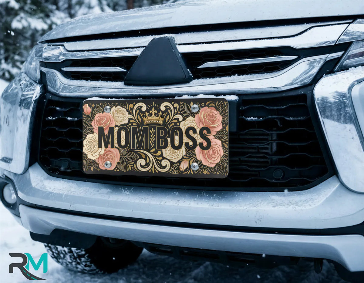 mom boss crown license plate on car in snowy setting — blush rose gold floral design