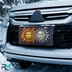 sun moon vanity plate on car in snowy setting — golden sun silver moon celestial design