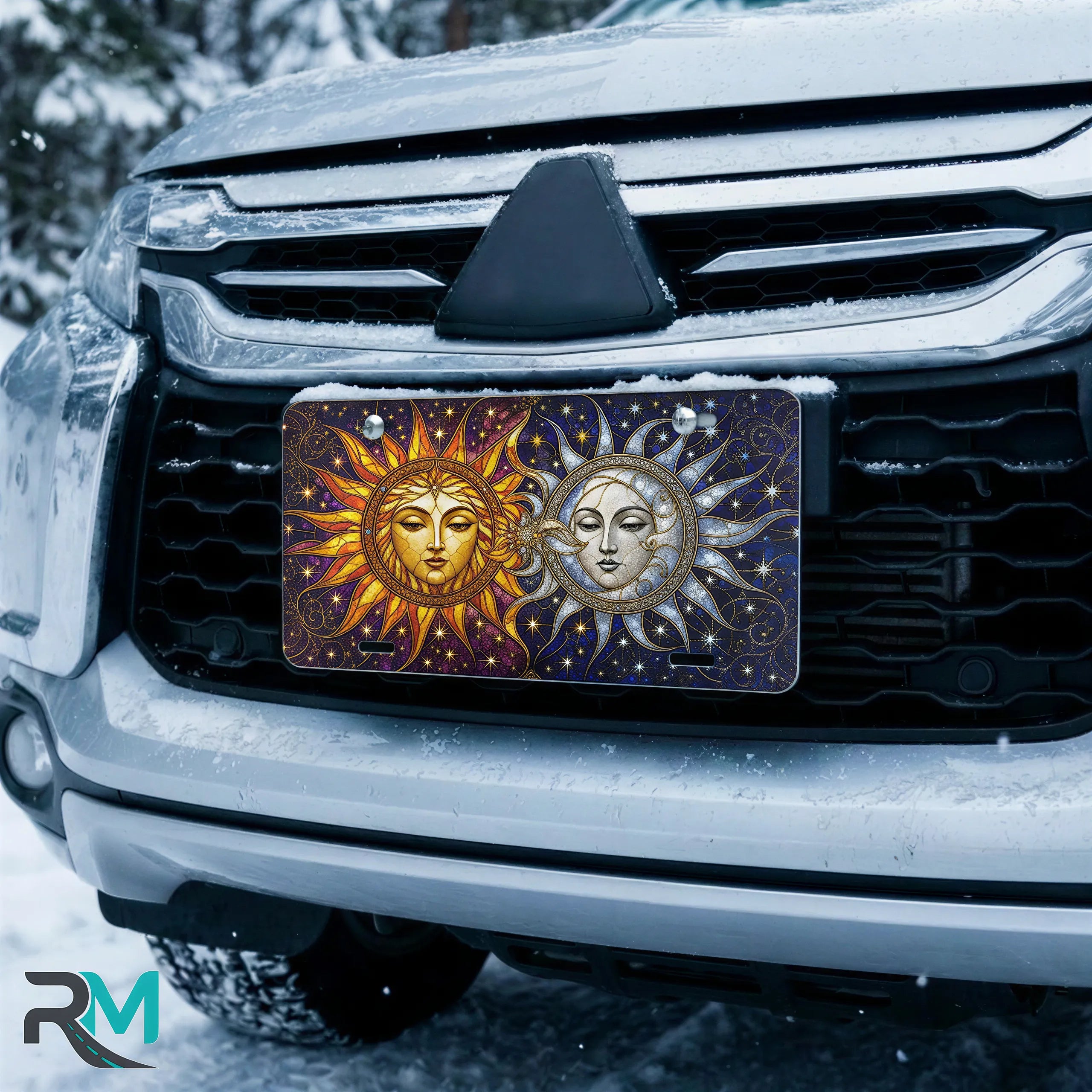 sun moon vanity plate on car in snowy setting — golden sun silver moon celestial design