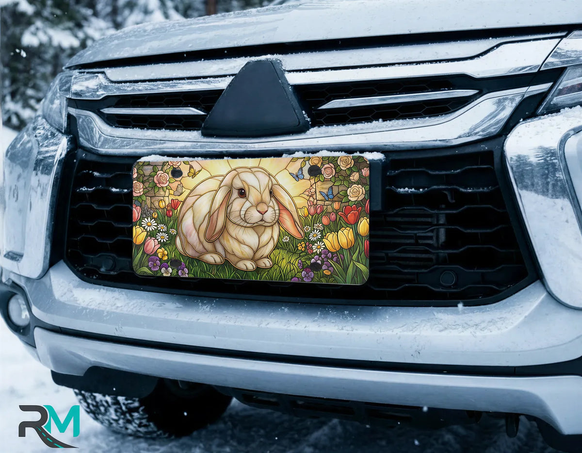 stained glass bunny vanity plate on car in snowy setting — soft pastel rabbit tulip rose design