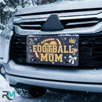 football mom license plate on car in snowy setting — navy football helmet sports design