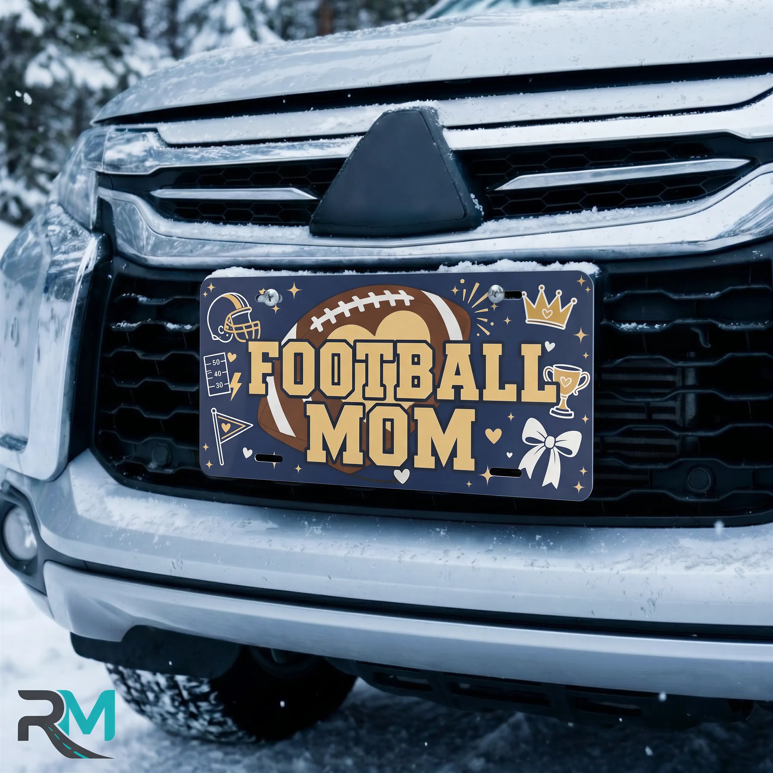 football mom license plate on car in snowy setting — navy football helmet sports design