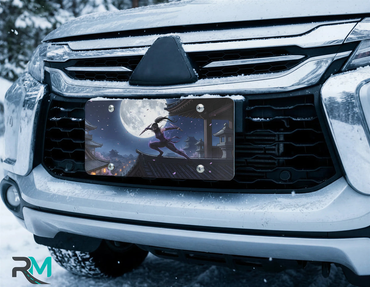 moonlit ninja vanity plate on car in snowy setting — glowing moon midnight ninja cherry blossoms design