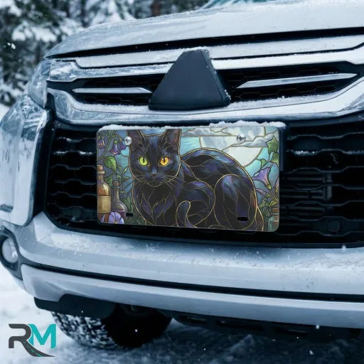 black cat stained glass vanity plate on car in snowy setting — jewel tone moonlit cat design