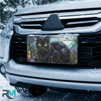 black cat stained glass vanity plate on car in snowy setting — jewel tone moonlit cat design