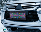 mom mobile license plate on car in snowy setting — neon retro pink blue yellow design