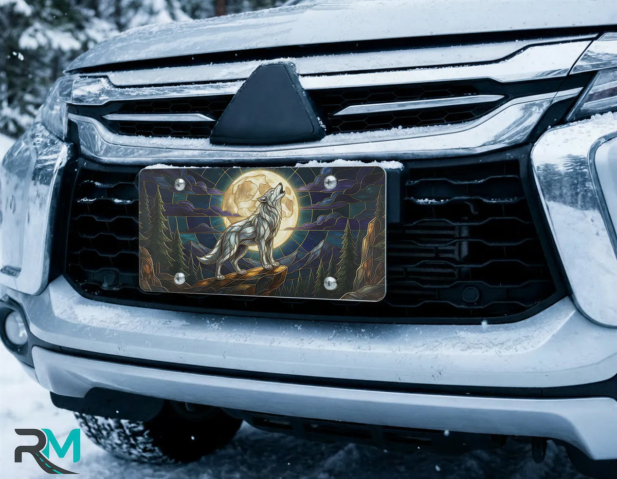 wolf moon license plate on car in snowy setting — midnight jewel-tone wolf howling design
