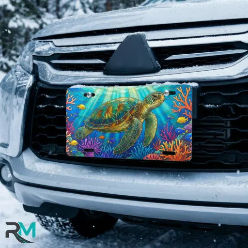 sea turtle vanity plate on car in snowy setting — vivid ocean blue coral reef design