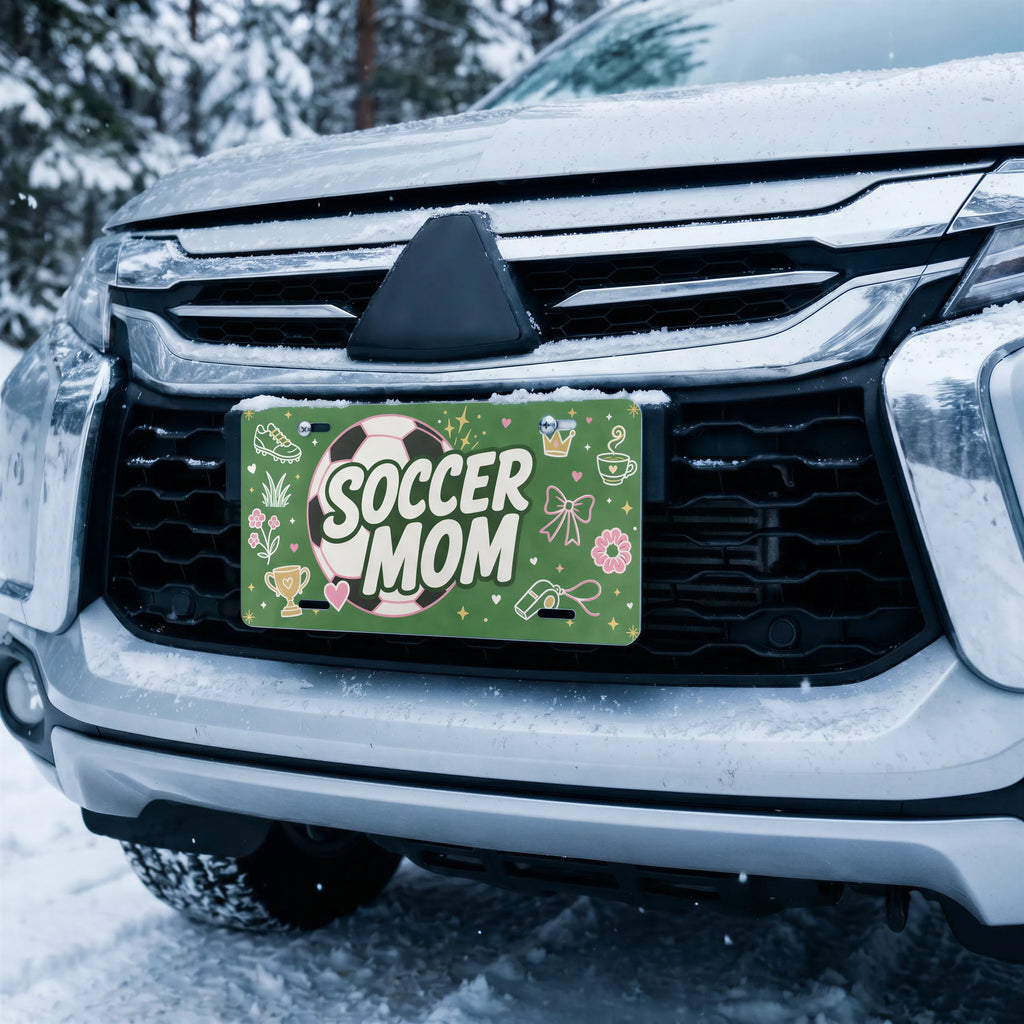 soccer mom license plate on car in snowy setting — pink ball green SOCCER MOM design