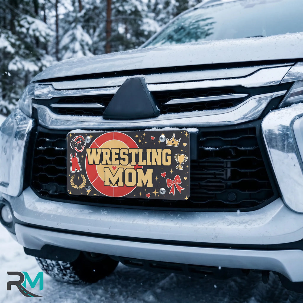 wrestling mom license plate on car in snowy setting — red gold headgear sports design