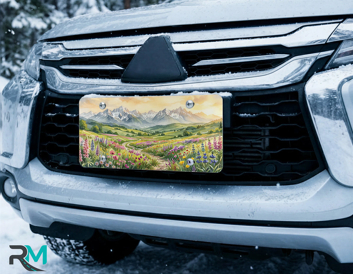 scenic mountain license plate on car in snowy setting — wildflower meadow watercolor design