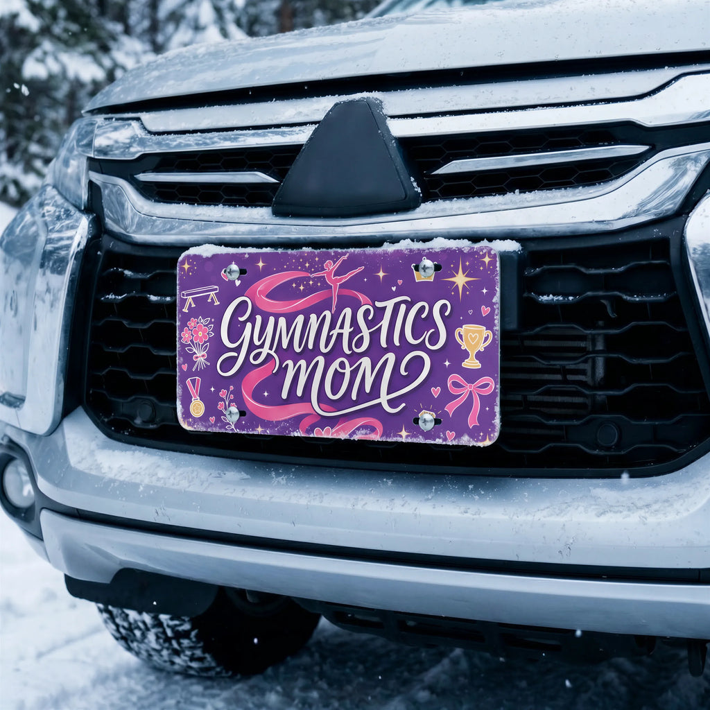 gymnastics mom license plate on car in snowy setting — purple pink ribbon gymnastics design