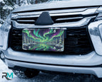 northern lights aurora vanity plate on car in snowy setting — vivid emerald violet aurora winter lake design