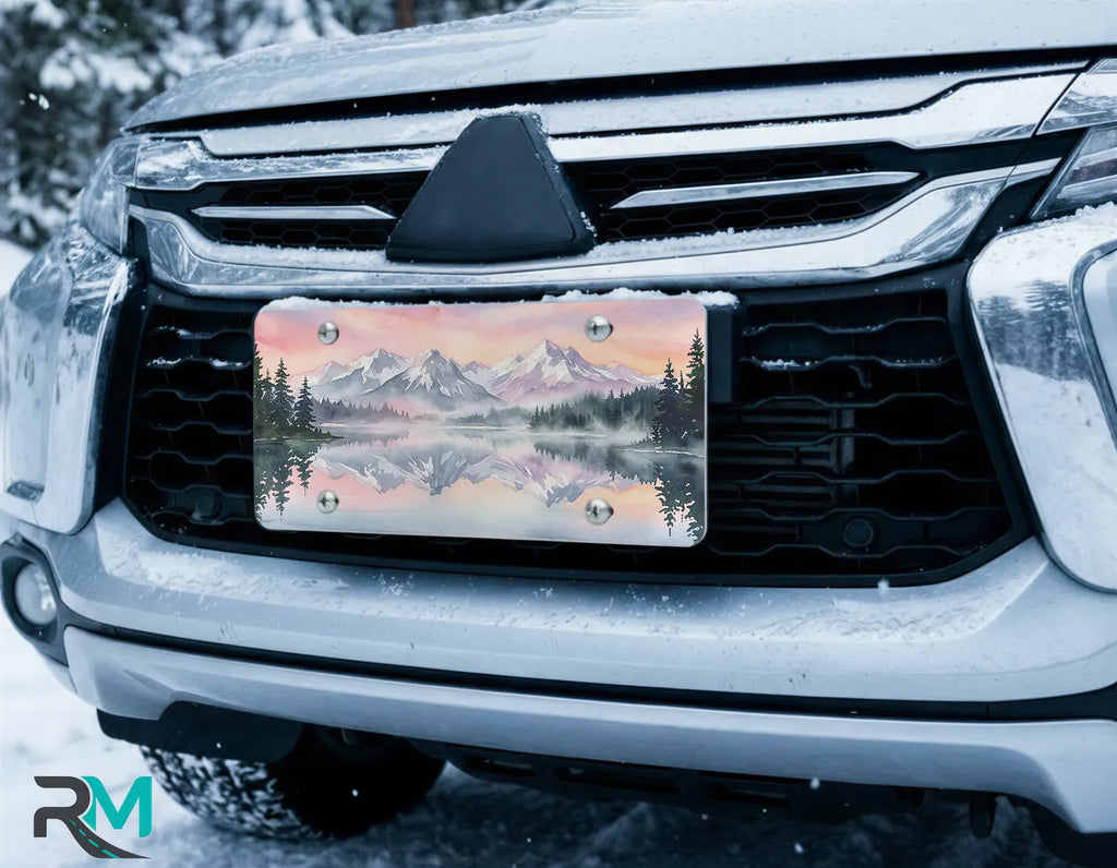 scenic alpine license plate on car in snowy setting — mountain lake reflection watercolor design