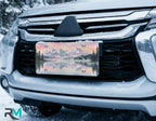scenic alpine license plate on car in snowy setting — mountain lake reflection watercolor design