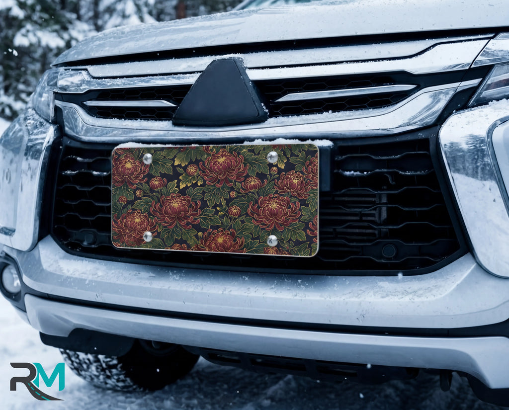 vintage floral chrysanthemum vanity plate on car in snowy setting — deep burgundy chrysanthemums lush green leaves design