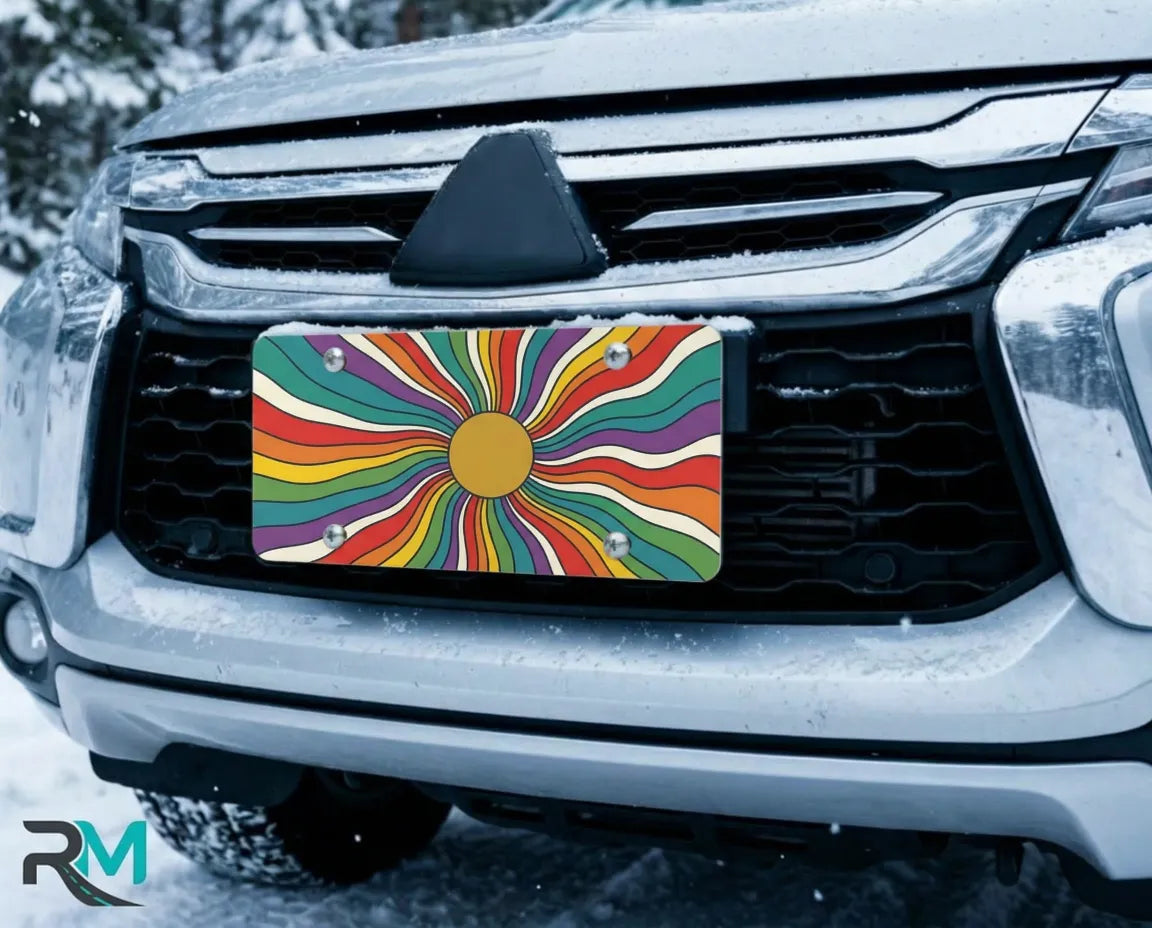 colorful rainbow license plate on car in snowy setting — retro sunburst design