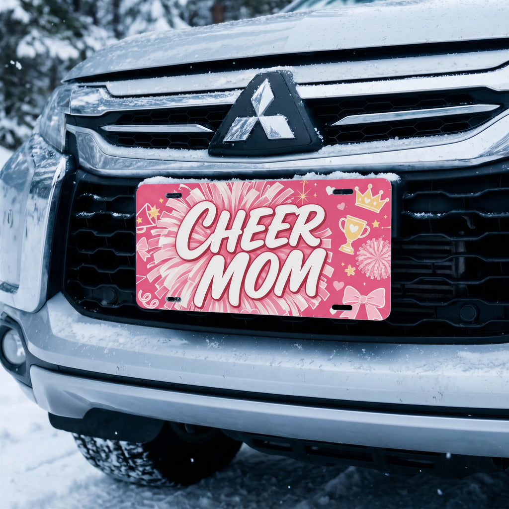 cheer mom license plate on car in snowy setting — hot pink pom-pom cheer design