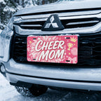 cheer mom license plate on car in snowy setting — hot pink pom-pom cheer design