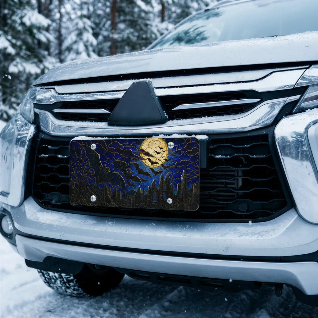 full moon bats vanity plate on car in snowy setting — midnight blue bat silhouette cracked moon design