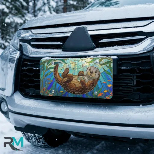 sea otter stained glass vanity plate on car in snowy setting — jewel teal otter kelp design