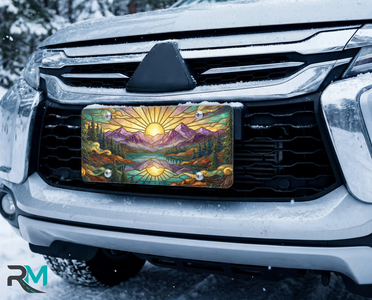 sunrise mountain lake vanity plate on car in snowy setting — warm gold purple mountain mirror lake design