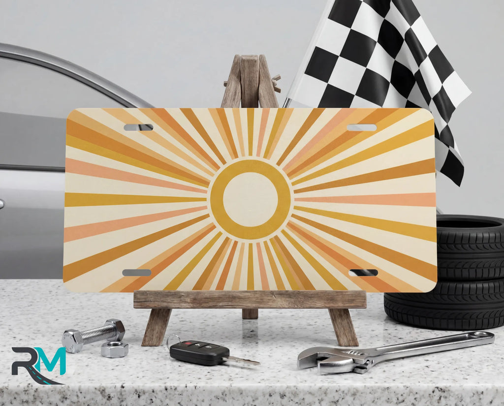 retro sunburst yellow vanity plate on display stand — soft mustard peach aluminum plate