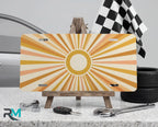 retro sunburst yellow vanity plate on display stand — soft mustard peach aluminum plate