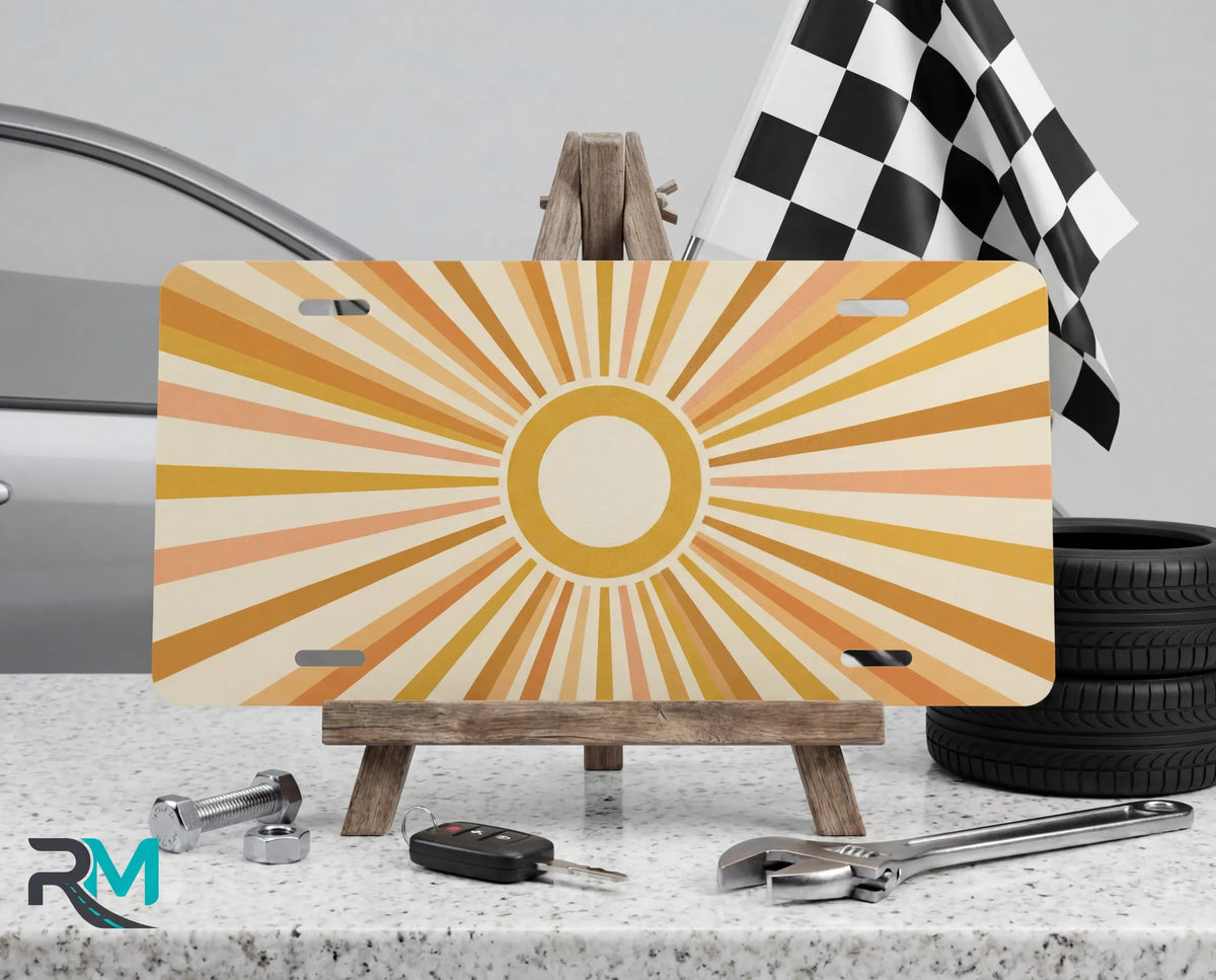 retro sunburst yellow vanity plate on display stand — soft mustard peach aluminum plate