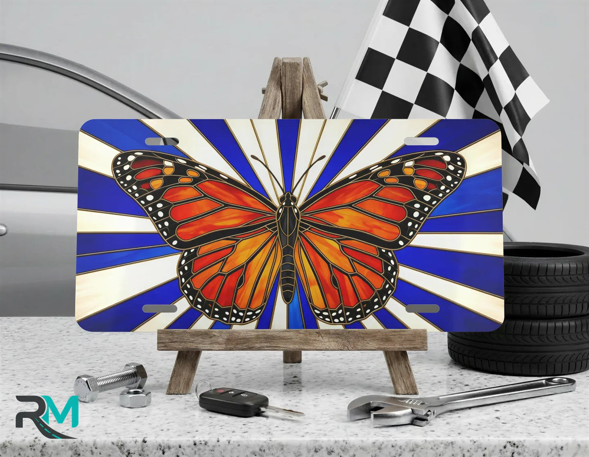 monarch butterfly vanity plate on display stand — vivid orange black nature license plate