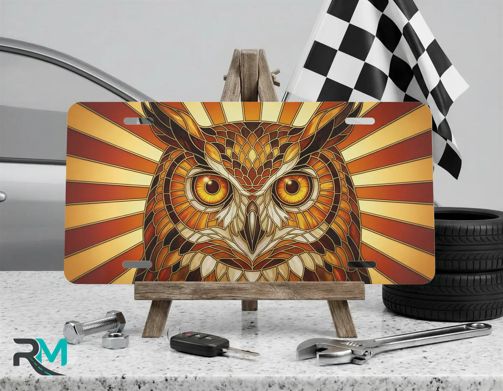 owl illustration vanity plate on display stand — warm amber gold wildlife aluminum plate