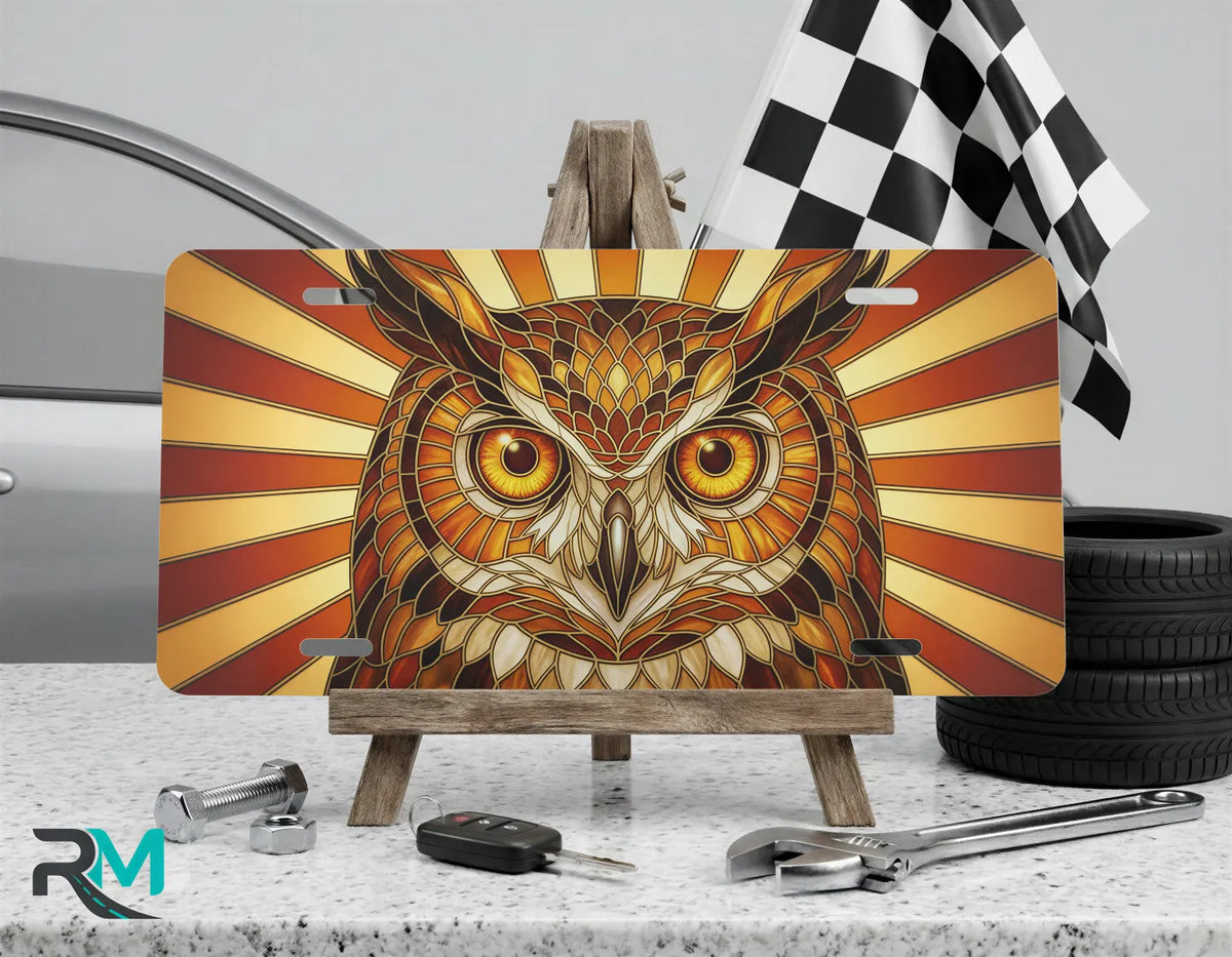 owl illustration vanity plate on display stand — warm amber gold wildlife aluminum plate