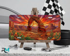 desert arch sunset cactus vanity plate on tire — warm amber southwestern arch scenic front license plate